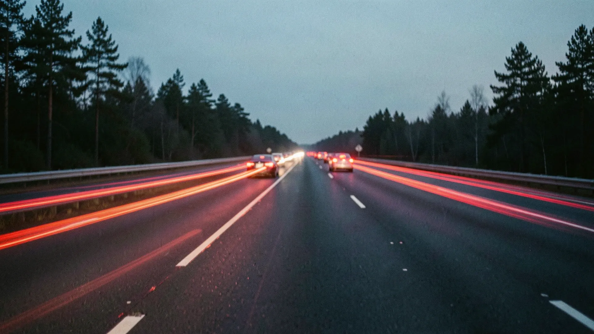 Illustration of red taillight streaks on a divided highway through pine woods at dusk